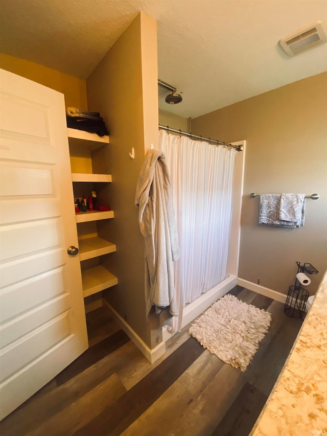 bathroom with wood-type flooring