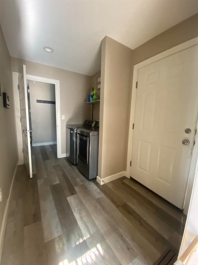 foyer entrance with washer and clothes dryer and dark hardwood / wood-style flooring