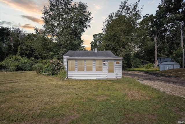 exterior space featuring a yard and a storage shed