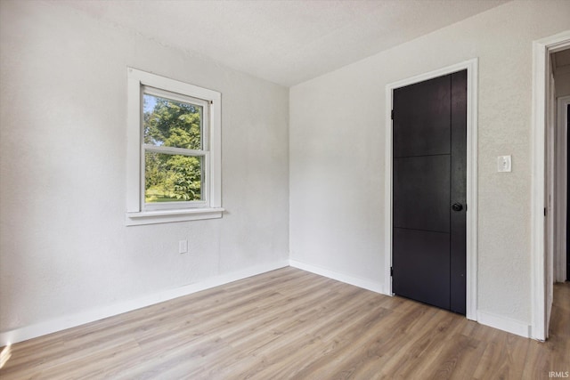 unfurnished bedroom featuring light wood-type flooring