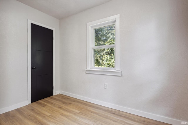 empty room with light hardwood / wood-style flooring