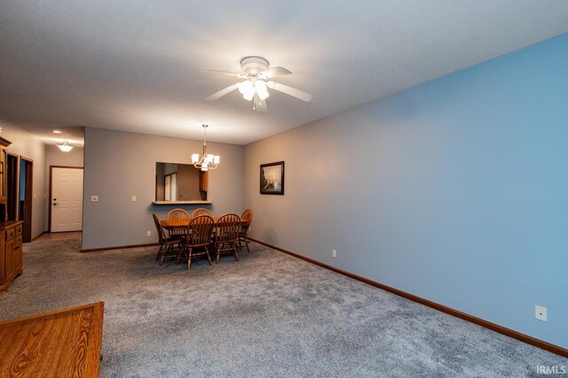 dining area with carpet flooring and ceiling fan with notable chandelier