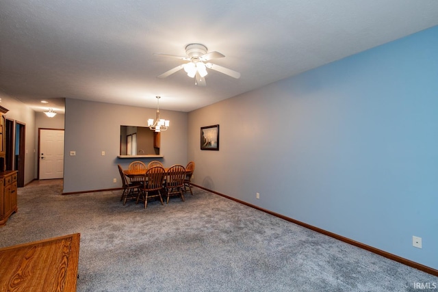 dining area with ceiling fan with notable chandelier and carpet