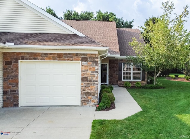 ranch-style home with a garage and a front lawn