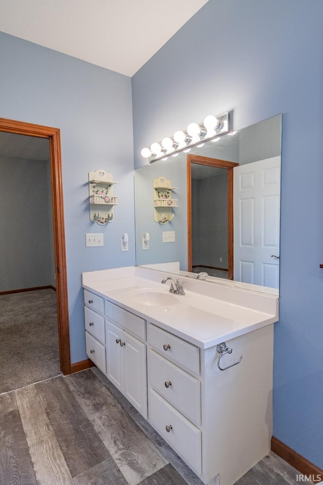 bathroom featuring hardwood / wood-style flooring and vanity