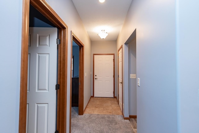 hallway featuring light colored carpet