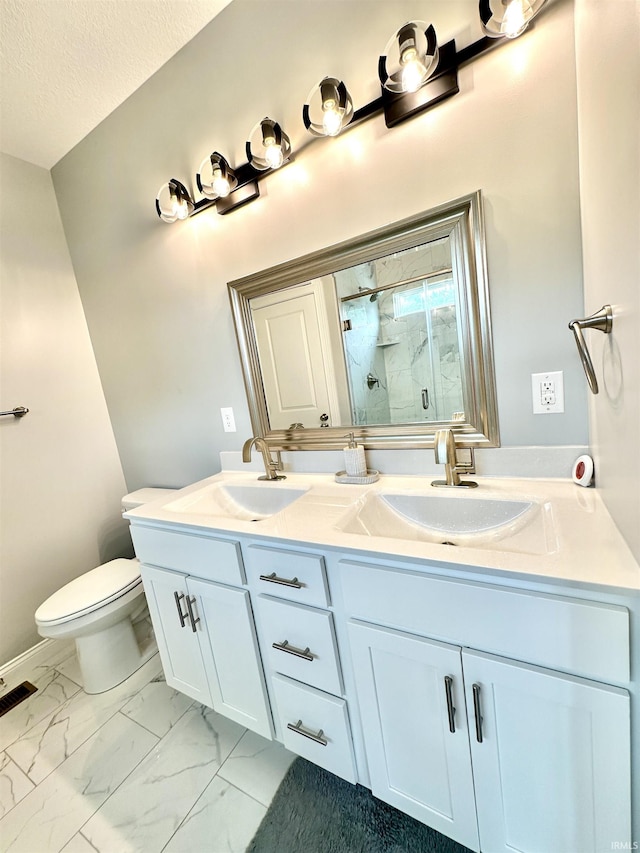 bathroom featuring vanity, toilet, an enclosed shower, and a textured ceiling