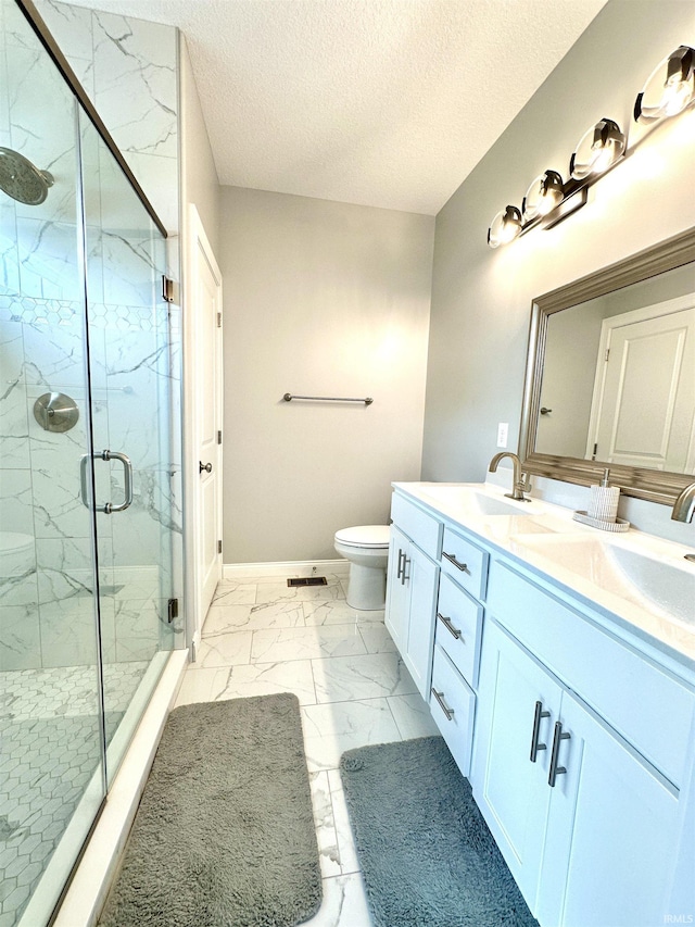 bathroom featuring vanity, an enclosed shower, a textured ceiling, and toilet