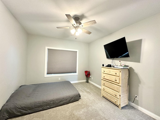 bedroom with light carpet and ceiling fan