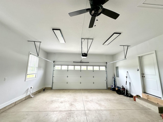 garage with a garage door opener and electric panel