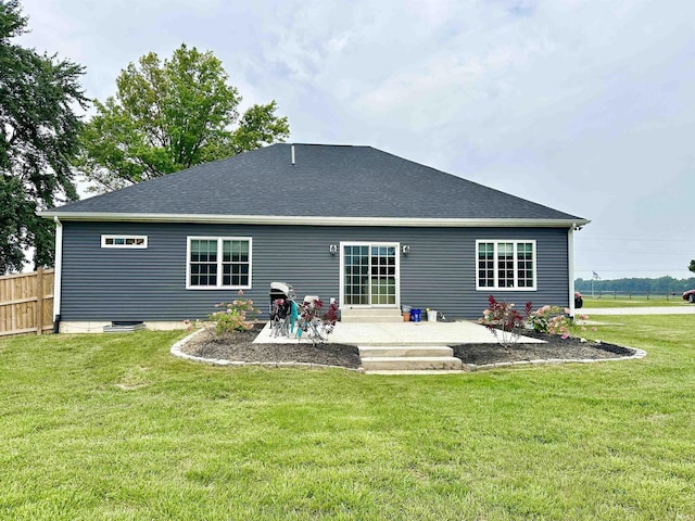 back of property with a lawn and a patio