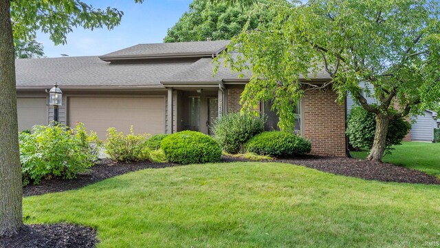 view of front of property with a garage and a front yard