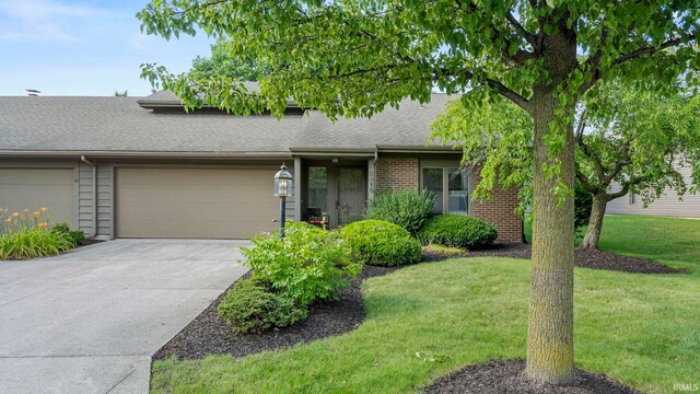 single story home with a garage and a front yard