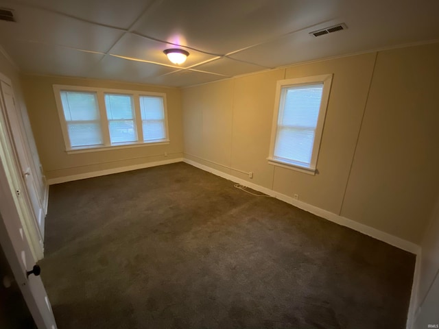 empty room with dark colored carpet