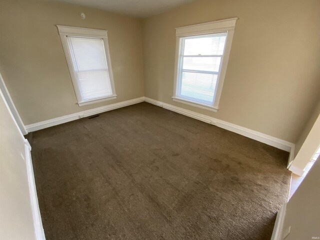 empty room with dark carpet