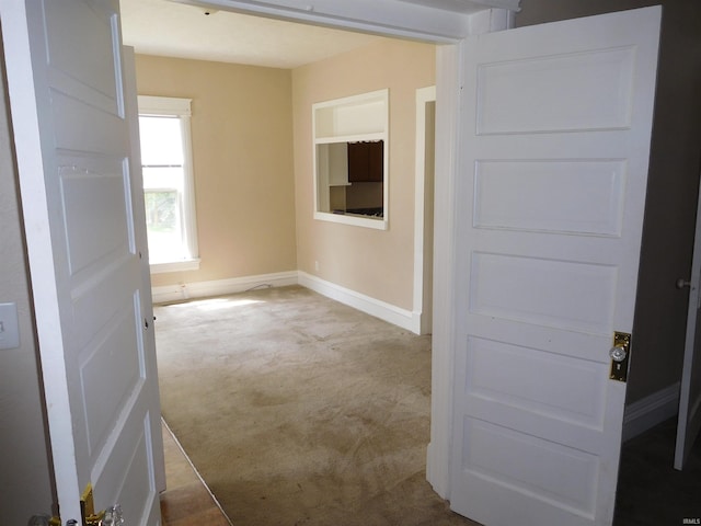 unfurnished room featuring light carpet