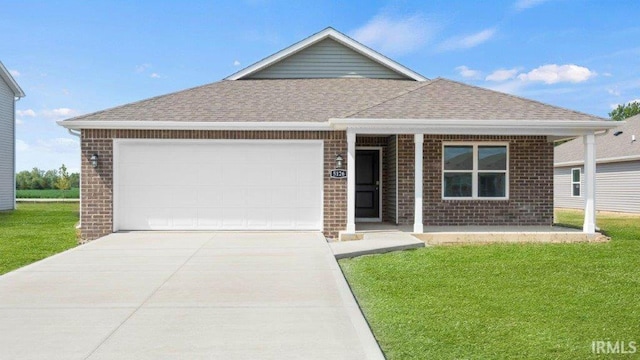 single story home with a garage and a front lawn