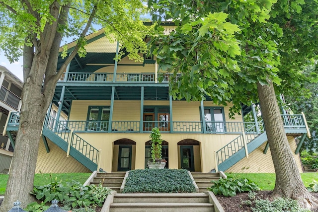 view of front of house featuring uncovered parking and stairway