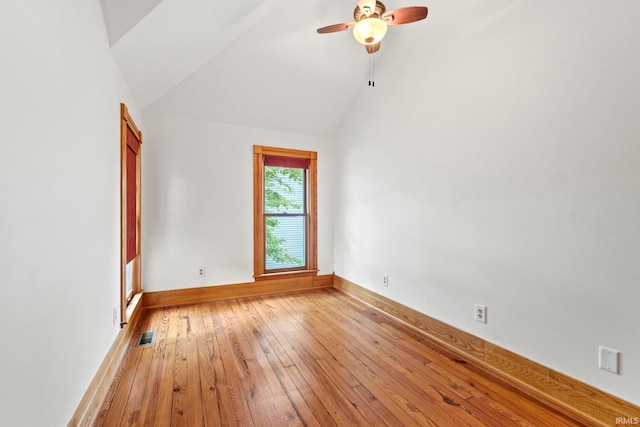 spare room featuring light wood-style floors, baseboards, visible vents, and a ceiling fan