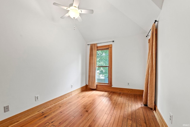 interior space with light wood-type flooring, vaulted ceiling, baseboards, and ceiling fan