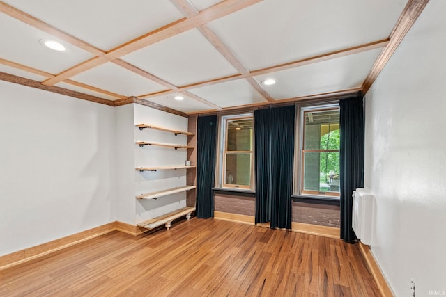 empty room with recessed lighting, coffered ceiling, baseboards, light wood-type flooring, and radiator heating unit