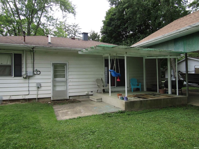 rear view of house featuring a yard