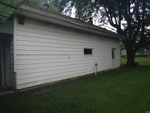 view of side of home featuring a lawn