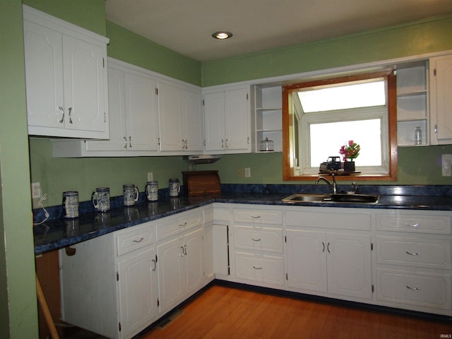 kitchen featuring sink, light hardwood / wood-style flooring, and white cabinets