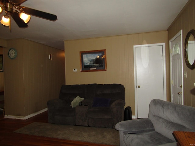 living room featuring ceiling fan and dark hardwood / wood-style flooring