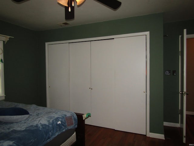 bedroom with dark hardwood / wood-style flooring and ceiling fan