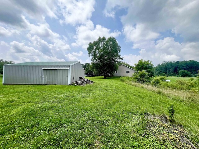 view of yard featuring an outbuilding and an outdoor structure