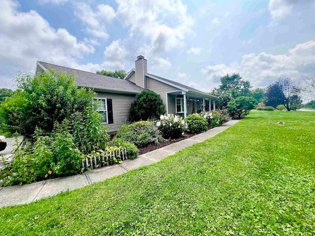 view of side of home with a lawn