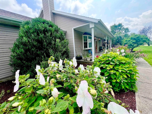 view of property exterior with covered porch