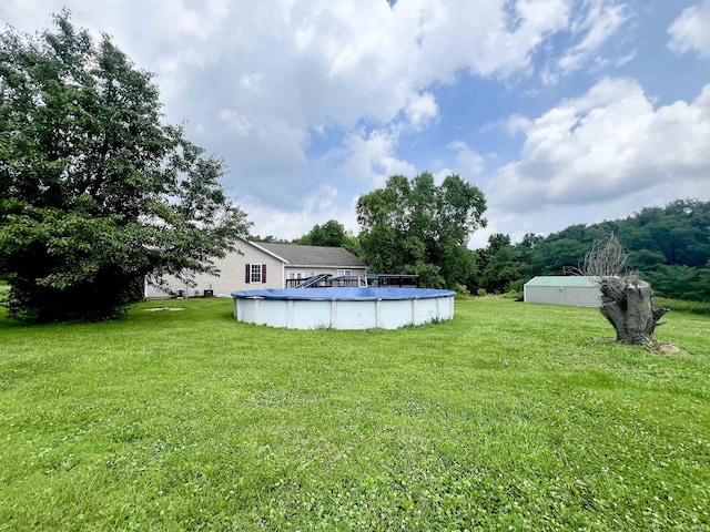 view of yard featuring a covered pool