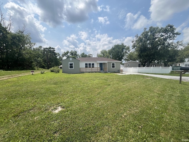 view of front of property with a front yard and fence