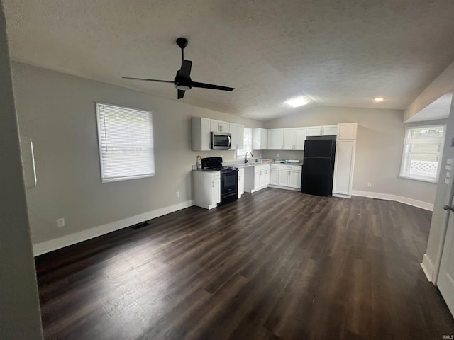 kitchen featuring dark wood-type flooring, light countertops, a textured ceiling, black appliances, and white cabinetry