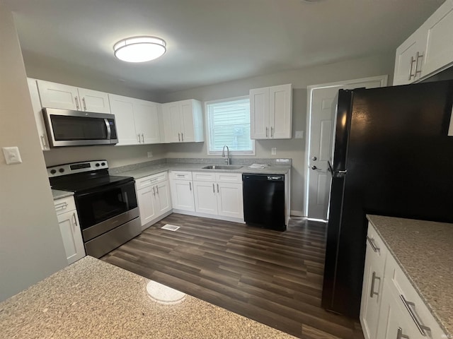 kitchen with black appliances, dark wood-type flooring, white cabinets, and a sink