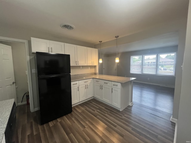 kitchen featuring pendant lighting, light countertops, freestanding refrigerator, white cabinets, and a peninsula