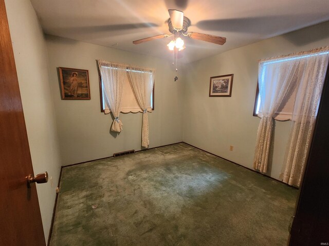 spare room featuring carpet floors and ceiling fan