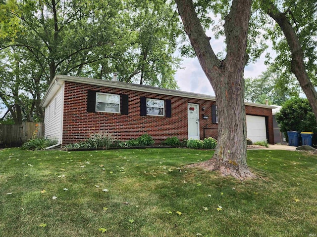 single story home featuring a garage and a front lawn