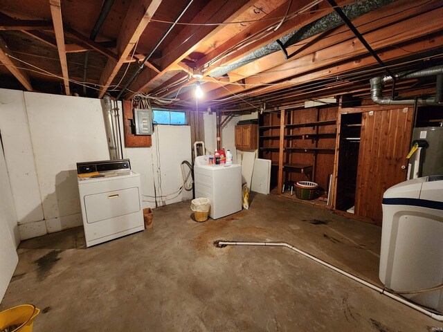 basement with electric panel, water heater, and washing machine and clothes dryer