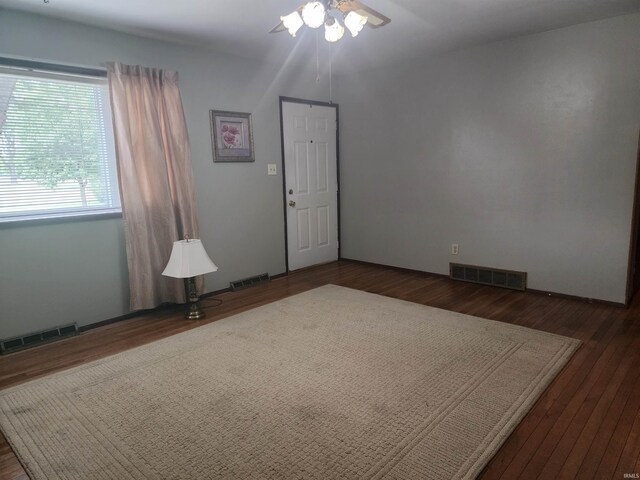 unfurnished room featuring ceiling fan and dark hardwood / wood-style floors