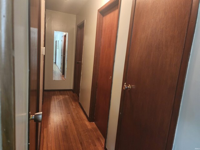 corridor with dark wood-type flooring