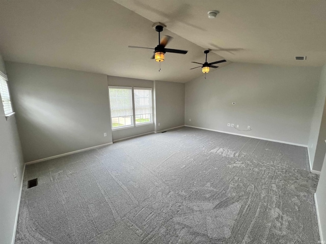 carpeted spare room featuring lofted ceiling