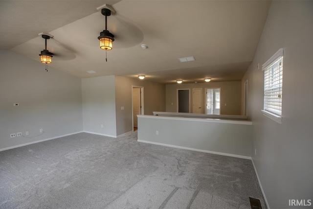 unfurnished room with vaulted ceiling and carpet