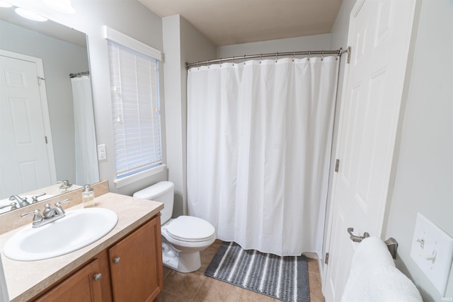 bathroom featuring vanity, tile patterned floors, and toilet