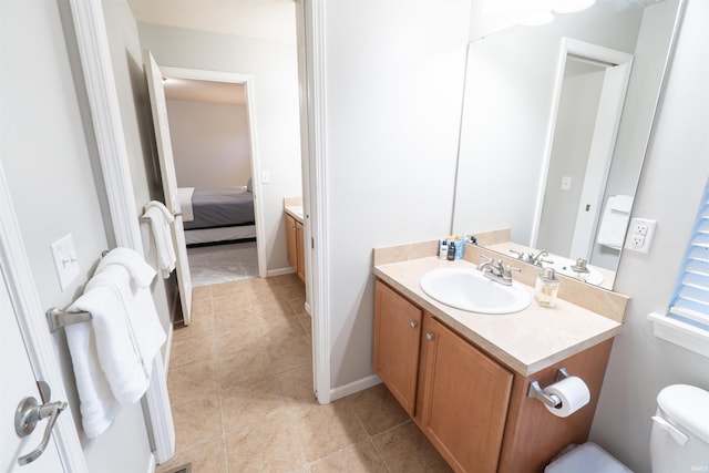 bathroom with vanity, toilet, and tile patterned flooring