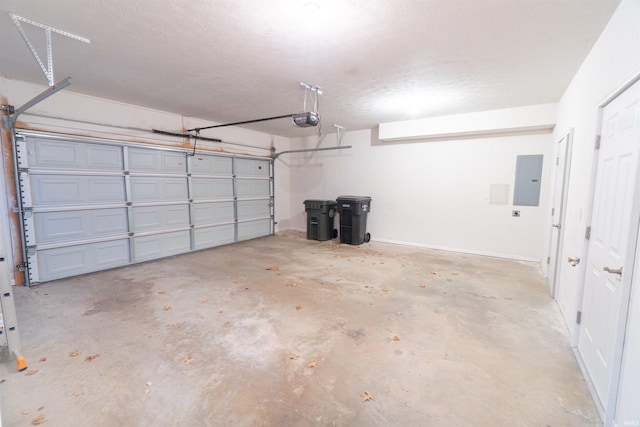 garage with a garage door opener and electric panel