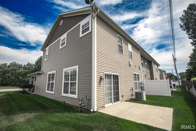 back of house with a patio area, central air condition unit, and a lawn