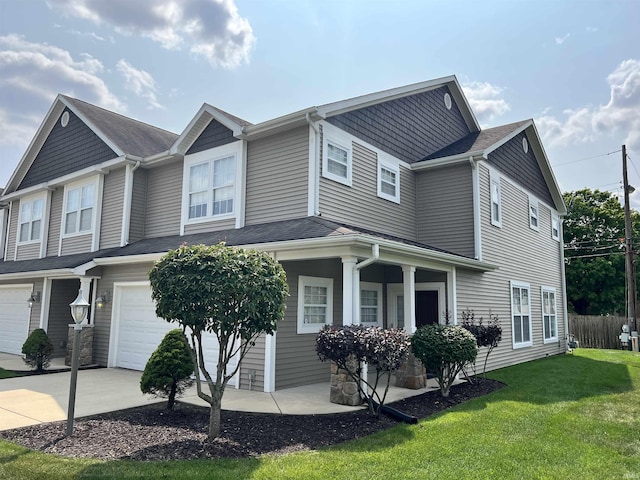 multi unit property featuring a garage and a front yard